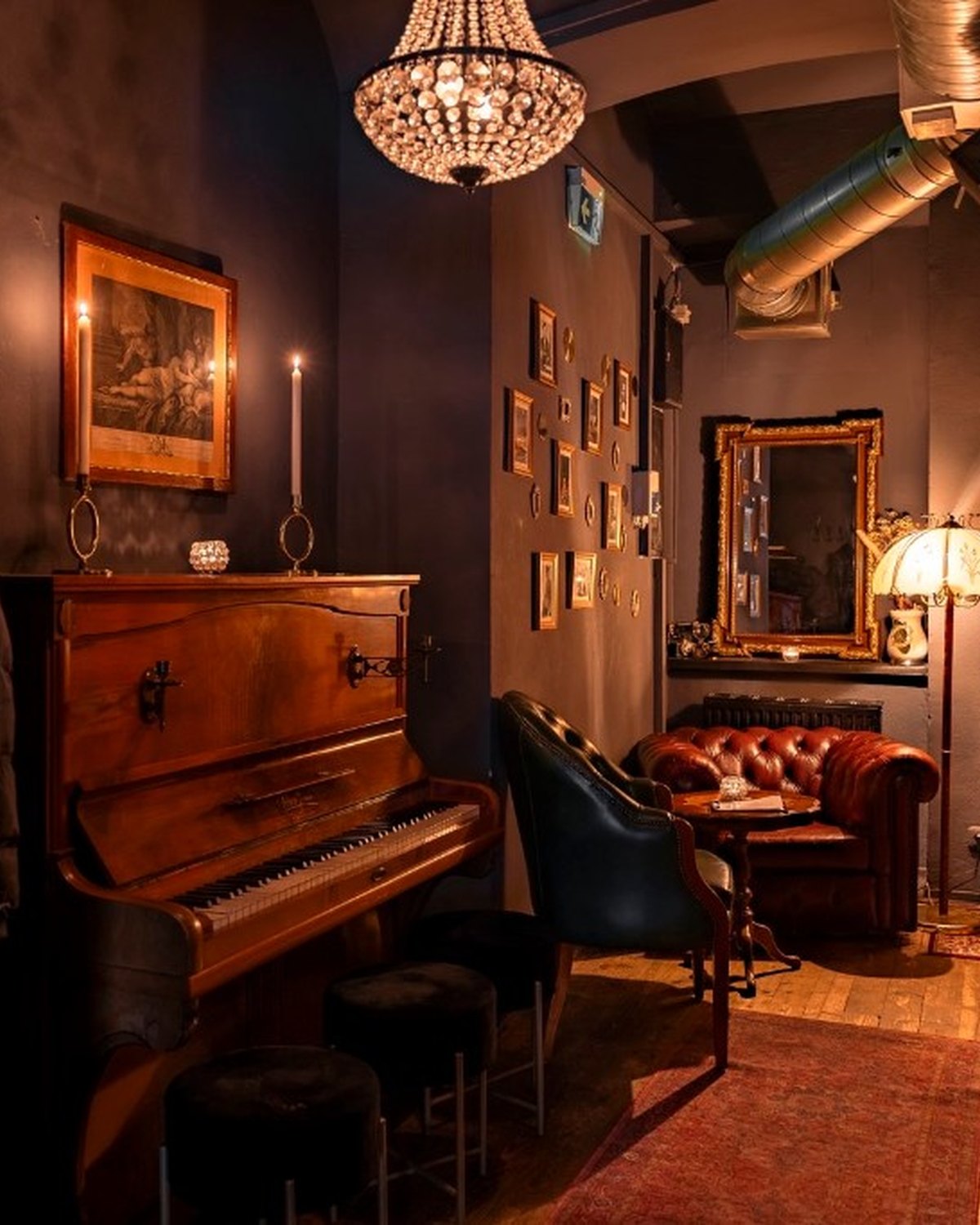 The lounge at Saint George, with piano, leather seating and warm light